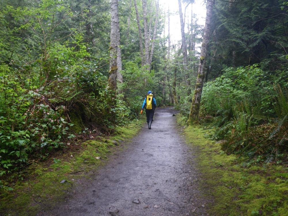 Along the wet trail: Kirsten hiking along the Smuggler Cove Park trail