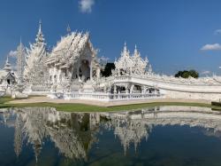 One of the main attraction in Chiang Rai is the White Temple.  It was built by a local artist and his students.  Partly a Buddhist temple but more a showcase for his artistic tastes.  He is skilled in sculpture,  painting, and medallions.