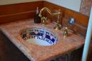 Bathroom sink in the visitors restroom: Original Pink Marble with tiled sink