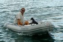 Jonas and Stormy trying out our new dinghy engine.  The big question:  will it plane?  Answer:  with one person and a small dog, yes it will!