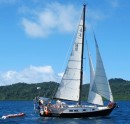 Spirare tacking between reefs near Kioa Island in Fiji: Coasting full sail with Yankee