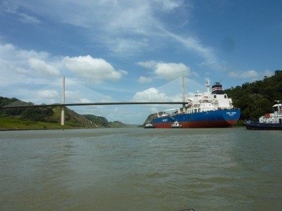 In this area of the canal all barges and freighters must be accompanied by tug assistance.  The canal is narrow from the Miraflores locks past the bridge.