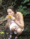 Christine eating mango at the Bwa Nef Falls while the fire roasts the bread fruit