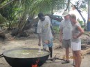 Tony and Mathilde watching someone stirring the Rondon (local soup made with fish, chicken, meat, spices, and pigtail). 