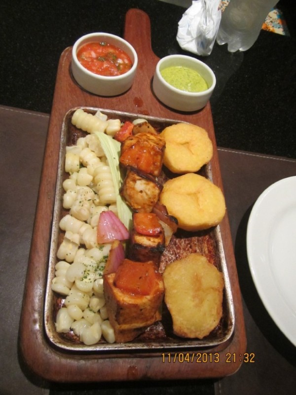 Typical Peruvian food - fish-k-bob with corn and potatoes and sauces.  Panchito restaurant. 