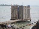 Self-cleaning commode over the sea.  As a result, they can not swim in the water at these populated islands.