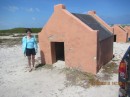 Gail by one of the many slave huts, barely big enough for a person to stand up in, used to house 4 slaves.