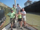 Gail, Tony and Garrow with Bryan and Bonnie on the bow in the Pedro Miguel Lock as the water goes down.