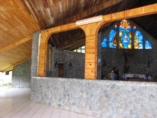 View of the church showing the low walls, allowing a view of the sea from inside.