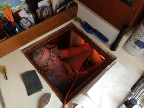Tony, the contortionist, fixing a water leak in a pipe underneath the galley countertop.  Successfully!