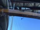Looking up at mast as we motor under bridge - Greg won’t look :) 