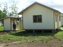 One of the project houses.  David is standing in front of the external bathroom.  A verandah would be nice in the tropical climate.