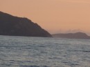 Approaching Cape Reinga (NW corner of NZ) at sunset - still calm!  Cape Maria Van Diemen in the distance (south of Cape Reinga)