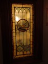 Meanwhile, a lone candle burns in a stain-glass window. (Meehans Irish Pub, Historic St. Augustine FL)