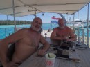 Brothers (from left) Ben and Ron, dubbed The Dutch Boys, relaxing on their aft deck with the flag of The Netherlands flying from the stern. (Van Straelen, Marina ZarPar, Boca Chica, Dominican Republic.)   