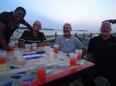That Wednesday night Rigo, the marina manager, throws a cruisers party on the patio by Restaurant Teresita at the marina. Pictured here, from left, are Rigo, Frank (a Dutch cruiser), Jim, and Ron (captain of the Dutch mine sweeper Van Straelen). (Marina ZarPar, Boca Chica, Dominican Republic.)