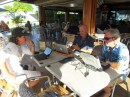 Jim (right) and Greg (left), whom we first met in Fiji, swap sea stories at Le Bout du Monde Restaurant on our last day at Port Moselle Marina.