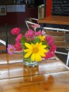 A variety of brightly colored flowers adorns a table at The Aquarium.