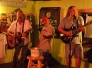 Back on home ground, friend Chris grabs a golf club and takes center stage to cut up with the band at Hurricane Pattys.