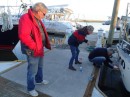 Jim (left) supervises as Kathrin and Juergen try to straighten the letters. (Rivers Edge Marina, St. Augustine FL)