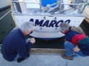 Juergen (left) and Kathrin adjust the letters for the new name of their boat. Amaroo, they tell us, is an Australian aborigine word meaning "tranquil place." (Rivers Edge Marina, St. Augustine FL)