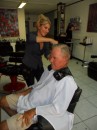 Jim getting hair cut in downtown Papeete by charming, vivacious French hair stylist.