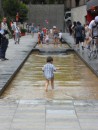 This little tyke, taking advantage of a water feature in a downtown plaza, has figured out that summer is here and !t is time to cool off!
Here he takes 