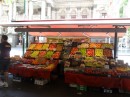 A produce stand lends color to a city street. 