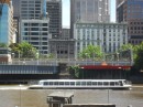 A ferry glides down the Yarra beside the Melbourne business district. 