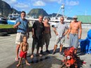 three-year-old Mateo (Hasta Manana) was on hand to supervise as cruising friends(from left) Kimball (Altaira); Jim (Cactus Wren); Joe (Panacea) and Hugo (Hasta Manana) helped Dan (far right) remove his engine (right foreground) from his boat (Leeway).