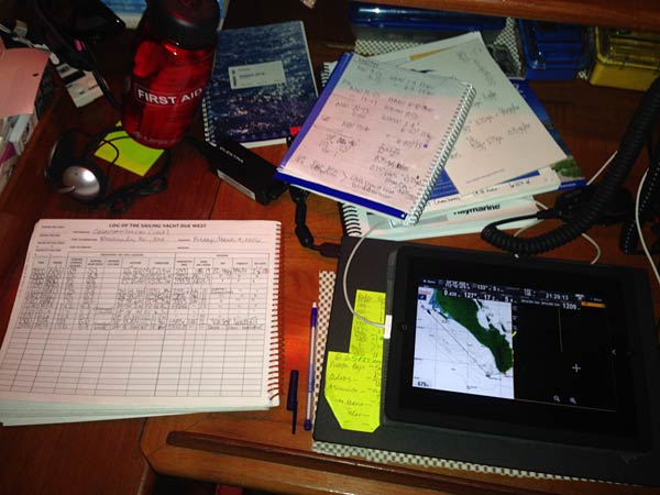 Nav station at night, log book at far left, and iPad repeater of chart plotter. On night passages we can check the course and radar from the iPad app that screen-shares our chart plotter. Pretty slick!