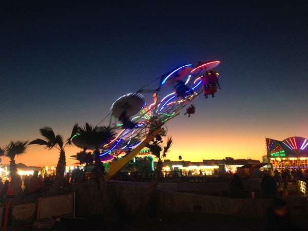 LED lights on all of the midway carnival rides light  up the sky against the lovely sunset ending to a fun-filed Carnaval week!