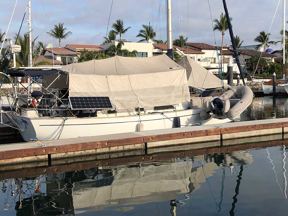 Due West in her normal summer mode with sunshade up. But when a hurricane is forecast, the sunshade quickly pulls back and ties up along the bimini frame (see next photo.)
