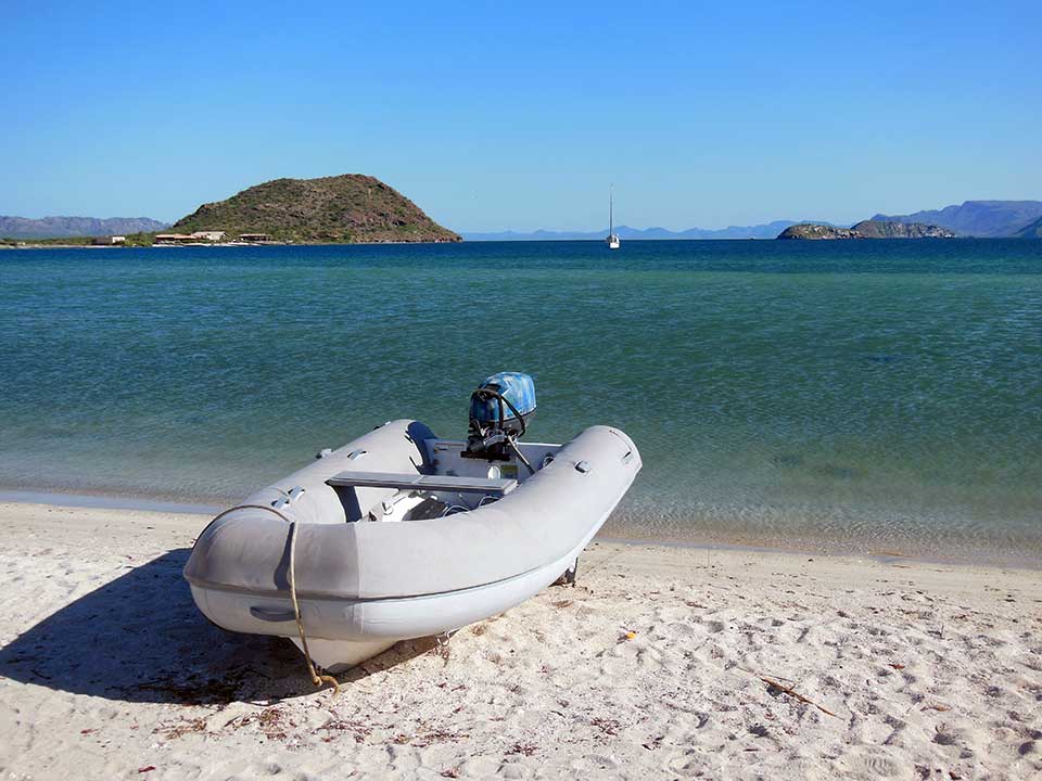Aventuras on Playa Sanispac with Due West riding comfortably on the hook in the background. The dinghy wheels worked great on this steep beach!