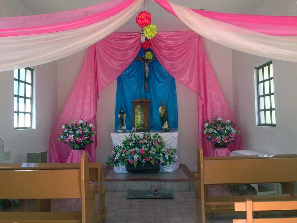 Inside of the two-pew chapel in the one-house town on the Road to San Javier.