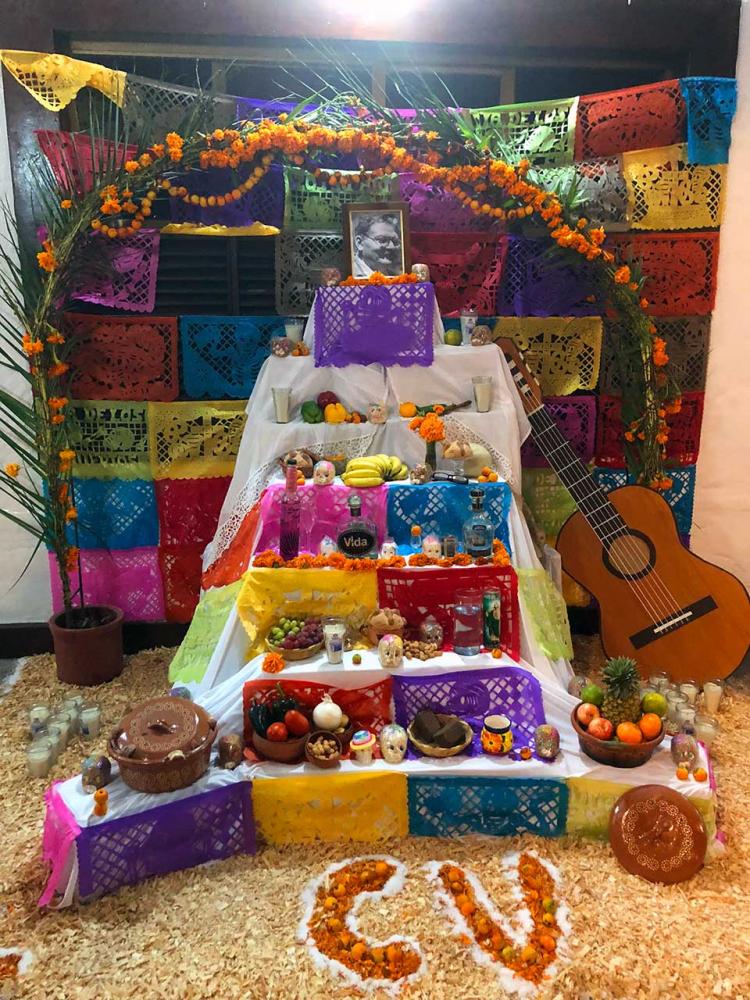 Dia de Los Muertos: one of the many family shrines displayed around town celebrating the lives of loved ones. Shrines typically include photos, favorite foods, drinks, and objects from the deceased. Marigolds are also used as their fragrance is said to lead the spirits back from beyond. It