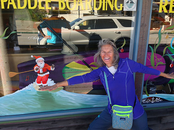 Heidi surfing with Santa in Morro Bay.