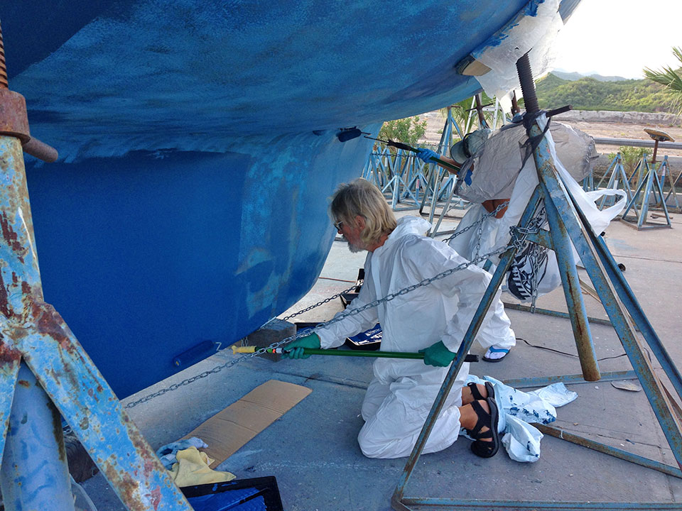 FINALLY ready for bottom paint...John (s/v Ingenium) and Heidi tackle the keel with BLUE.