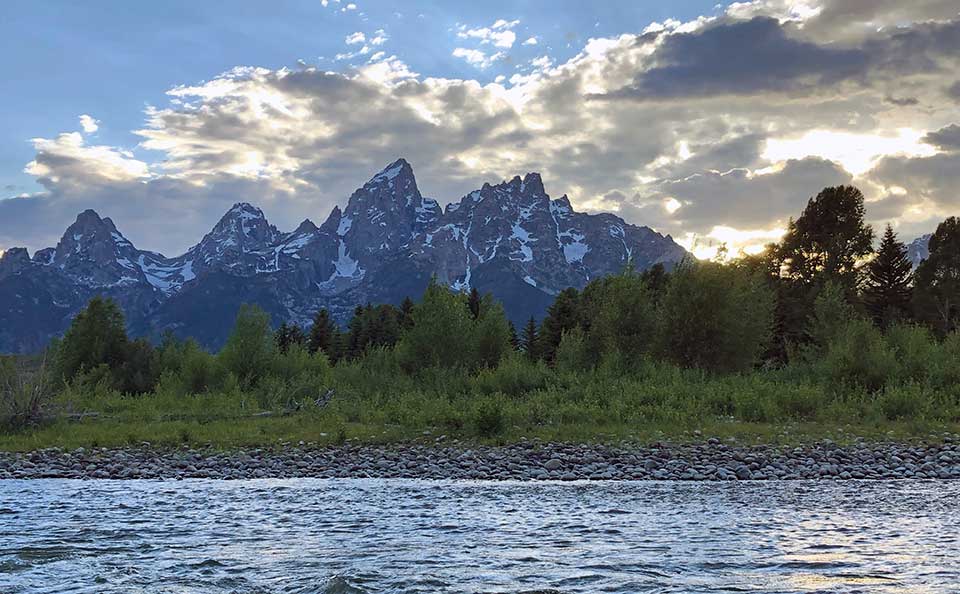Spectacular view of the sunset over the Grand Tetons from the middle of the Snake River. THIS is why we prefer the evening float...