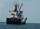 The Coast Guard ship was picking up the buoys and placing them on their ship.