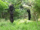 Old palm trees are carved into statues
