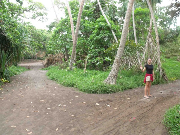 Tara taking the path around the traditional kava drinking area to the left. If women enter, the men throw rocks at them.