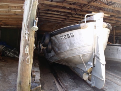 "Moss". One of three longboats used to get through the surf and out to supply ships