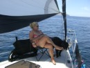 Ah... some spinnaker shade, calm seas.  Why not sit on the foredeck in a comfy chair.