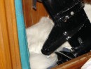 Snowshoe asleep behind the Mercury outboard motor stowed in the stern head.