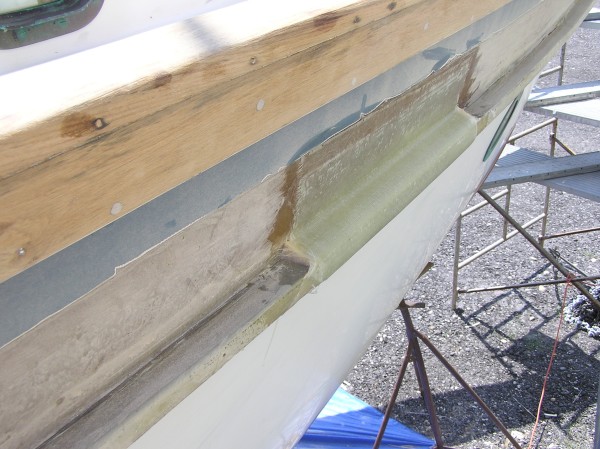 Here is the test lamination to see if we could get two layers of heavy structural fiberglass, and one layer of a lighter cloth, all saturated in epoxy resin to lay up around the existing rub rail.  It worked out just fine.