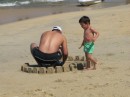Father and son building a sand castle.