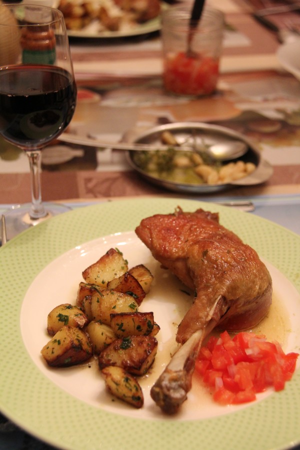 French Home cooking: confit duck leg with roast potatoes and tomato salsa