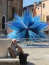 Peter waiting oh so patiently for one who has gone shopping for items made of Murano glass - note public display of modernistic vivid blue Murano glass in background