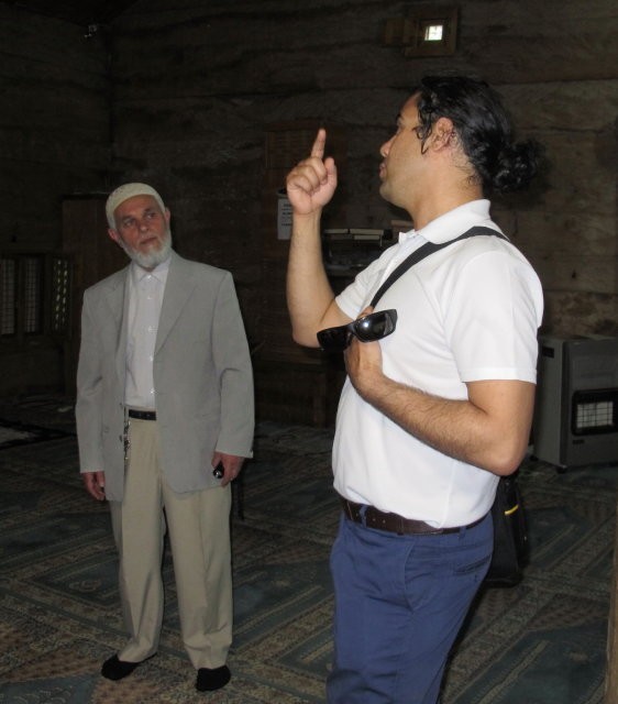 18 Apr 14: Our tour guide Tas speaking with the Mullah of a very old mosque - one which was built without the benefit of nails.